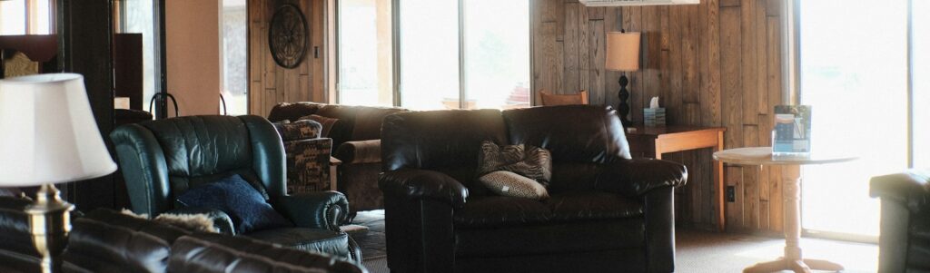 a living room filled with furniture and a ceiling fan