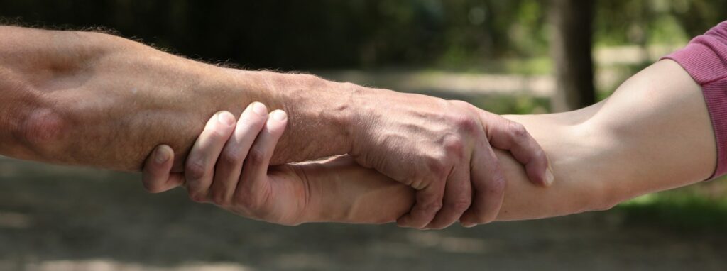 a close up of two people holding hands