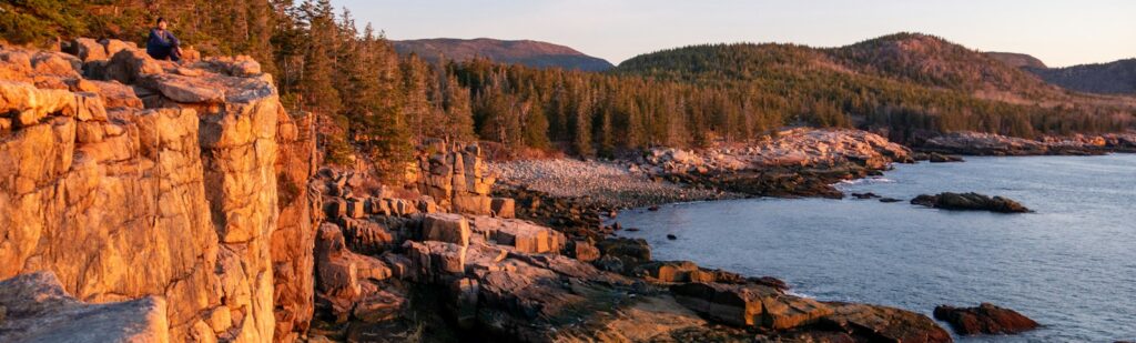 a rocky cliff overlooks a body of water